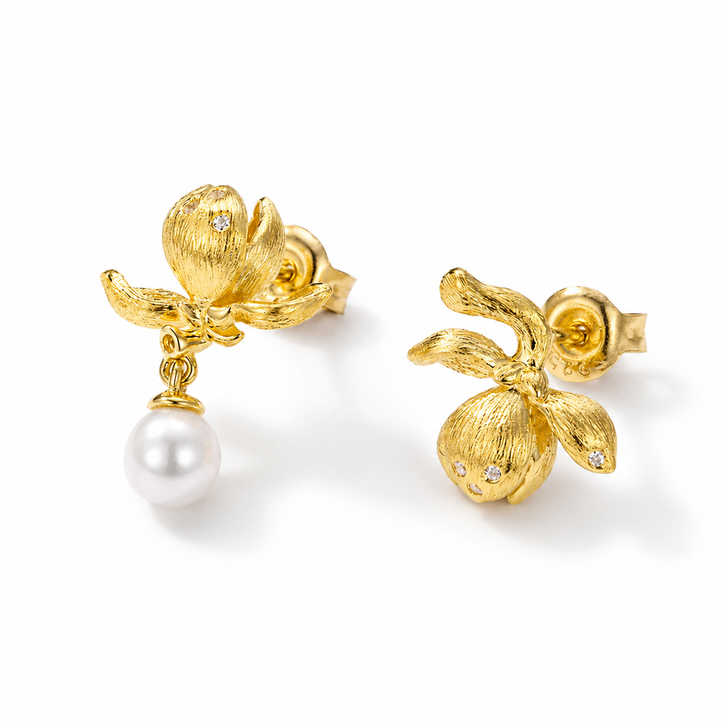 Golden Flora Pearl Studs featuring delicate gold flowers and a classic pearl drop, embodying timeless elegance.